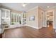 This open-concept living room features hardwood floors, custom built-ins, and natural light from shuttered windows at 3920 Ineal Dr, Cumming, GA 30028