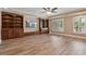 Large living room features wood floors, built-in cabinets, recessed lighting, and large windows at 3920 Ineal Dr, Cumming, GA 30028