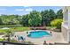 Inviting backyard pool featuring mature trees, manicured landscaping and stylish patio furniture at 3920 Ineal Dr, Cumming, GA 30028