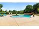 Inviting kidney-shaped pool featuring a brick border and spacious concrete patio with lounge chairs at 3920 Ineal Dr, Cumming, GA 30028