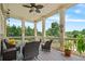 Charming covered porch features comfortable seating and a peaceful view of the surrounding landscape at 3920 Ineal Dr, Cumming, GA 30028