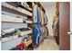 Custom walk-in closet with ample shelving, hanging storage, and carpeted floors at 3920 Ineal Dr, Cumming, GA 30028