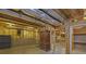Unfinished basement area with exposed ductwork, concrete walls, and built-in wooden shelves at 4810 Duncans Lake Dr, Buford, GA 30519