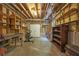 Unfinished basement with exposed ceiling, wooden shelving, work bench, and double doors at 4810 Duncans Lake Dr, Buford, GA 30519