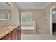 Granite counters accent the cabinets in this bathroom with tub and shower combo at 4810 Duncans Lake Dr, Buford, GA 30519