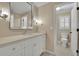 Bright bathroom with single sink vanity with large mirror and toilet with window at 4810 Duncans Lake Dr, Buford, GA 30519