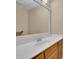 Bathroom vanity with a large mirror and solid surface counter top with wood cabinets at 4810 Duncans Lake Dr, Buford, GA 30519