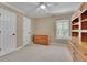 Well-lit bedroom featuring neutral walls, window with shutters, and wood furniture at 4810 Duncans Lake Dr, Buford, GA 30519
