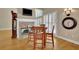 Cozy dining area with a stone fireplace and a dark wood table set at 4810 Duncans Lake Dr, Buford, GA 30519