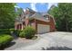 Side view of a brick home with a two-car garage and well-maintained landscaping at 4810 Duncans Lake Dr, Buford, GA 30519