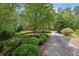 Beautiful brick home with lush landscaping, mature trees, and a private driveway at 4810 Duncans Lake Dr, Buford, GA 30519
