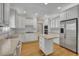 Bright kitchen features white cabinetry, stainless steel appliances, and a functional kitchen island at 4810 Duncans Lake Dr, Buford, GA 30519