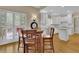Eat-in kitchen featuring bright, white cabinetry, stainless steel appliances, and hardwood flooring at 4810 Duncans Lake Dr, Buford, GA 30519