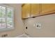 Laundry room with a window and upper cabinets and hookups for washer and dryer at 4810 Duncans Lake Dr, Buford, GA 30519