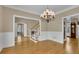 Open-concept dining area featuring chandelier lighting and views to multiple rooms at 4810 Duncans Lake Dr, Buford, GA 30519