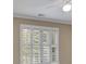 Living room area with large windows and white window shutters at 4810 Duncans Lake Dr, Buford, GA 30519