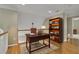 Comfortable home office with wooden desk, shelving, and hardwood floors at 4810 Duncans Lake Dr, Buford, GA 30519