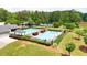 Community pool with lake and tennis courts access surrounded by mature trees and lush greenery at 4810 Duncans Lake Dr, Buford, GA 30519
