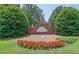 Community entrance sign for Duncans Lake with landscaping, red flowers and green shrubs at 4810 Duncans Lake Dr, Buford, GA 30519