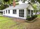 This home features a screened-in porch, brick chimney, and fenced-in yard at 5091 Newark Ave, Clarkdale, GA 30111