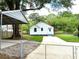 Back of cottage with carport featuring a well-kept yard, carport, and easy access at 5091 Newark Ave, Clarkdale, GA 30111