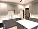 Modern kitchen with gray cabinets, stainless steel appliances and a center island at 5091 Newark Ave, Clarkdale, GA 30111