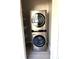 Laundry closet with stackable washer and dryer unit at 5091 Newark Ave, Clarkdale, GA 30111
