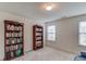 Bedroom featuring built-in bookcases for ample storage and natural light from windows at 512 Antler Ln, Suwanee, GA 30024