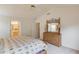 Bright bedroom featuring a spacious layout, ensuite bathroom, and a wooden dresser with decor at 512 Antler Ln, Suwanee, GA 30024