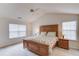 Serene bedroom with vaulted ceiling, natural wood furniture, and two sunny windows at 512 Antler Ln, Suwanee, GA 30024