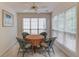 Bright breakfast nook featuring a round table, four chairs and large sun-filled windows at 512 Antler Ln, Suwanee, GA 30024