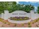 Deer Valley community entrance sign surrounded by colorful flowers and lush greenery at 512 Antler Ln, Suwanee, GA 30024