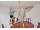 Well-lit dining area featuring crown molding, with staircase and glimpse into the living room at 512 Antler Ln, Suwanee, GA 30024