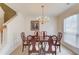 Formal dining room with elegant chandelier, classic wainscoting, and a large window at 512 Antler Ln, Suwanee, GA 30024