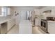 Bright kitchen with white cabinets, stainless steel appliances, and a functional center island at 512 Antler Ln, Suwanee, GA 30024