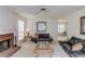 Spacious living room featuring a fireplace, neutral carpeting, and view into the dining area at 512 Antler Ln, Suwanee, GA 30024