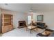 Cozy living room featuring a brick fireplace, comfortable seating, and built-in shelving at 512 Antler Ln, Suwanee, GA 30024