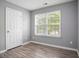 A simple bedroom featuring laminate flooring and a window offering natural light at 5244 Carrington Park Dr, Powder Springs, GA 30127