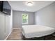 Bedroom featuring laminate flooring, neutral walls, and a window for natural light at 5244 Carrington Park Dr, Powder Springs, GA 30127