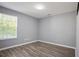 Bedroom featuring natural light from a window and modern flooring at 5244 Carrington Park Dr, Powder Springs, GA 30127
