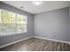 Bedroom featuring laminate flooring and a window offering natural light at 5244 Carrington Park Dr, Powder Springs, GA 30127