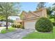 Traditional two-story home featuring a two-car garage and well-manicured landscaping at 5244 Carrington Park Dr, Powder Springs, GA 30127