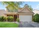 Charming two-story home featuring a brick facade and a two-car garage, surrounded by mature landscaping at 5244 Carrington Park Dr, Powder Springs, GA 30127