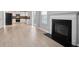 Bright living room features hardwood-style floors, fireplace, and seamless flow to the kitchen at 5244 Carrington Park Dr, Powder Springs, GA 30127