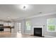 Cozy living room with fireplace, seamlessly connected to a modern kitchen and sliding doors at 5244 Carrington Park Dr, Powder Springs, GA 30127