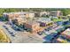 Aerial view of a well-planned mixed-use development, showcasing tree-lined streets and diverse buildings at 12084 Cotton Aly, Alpharetta, GA 30009