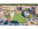 An inviting aerial view of a walkable mixed-use community with a central green and fountain at 12084 Cotton Aly, Alpharetta, GA 30009