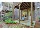 Backyard area offering a shaded patio and stone pathway amidst beautiful greenery at 12084 Cotton Aly, Alpharetta, GA 30009