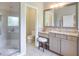 Elegant bathroom featuring a glass shower, granite counters, and vanity with a furry stool at 12084 Cotton Aly, Alpharetta, GA 30009