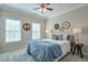 Relaxing bedroom with two windows, a ceiling fan, and a comfortable bed adorned with stylish pillows at 12084 Cotton Aly, Alpharetta, GA 30009